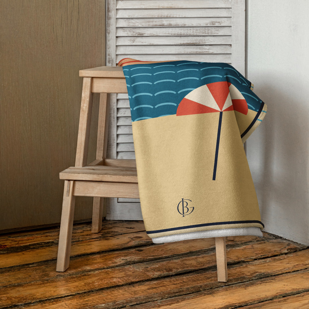 The Do Not Disturb Beach Towel, draped over a stool