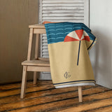 The Do Not Disturb Beach Towel, draped over a stool