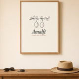 The Amalfi Art Print, framed above a hallway console with sunglasses and a straw hat