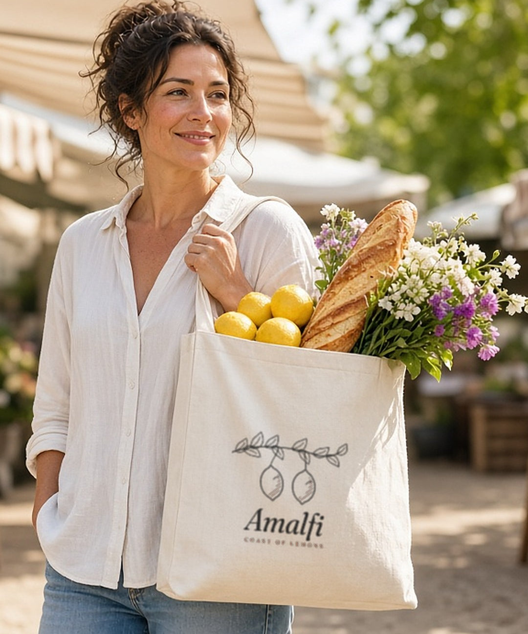 The Amalfi Tote in Oyster, overfilled and carried through a sunny farmers market