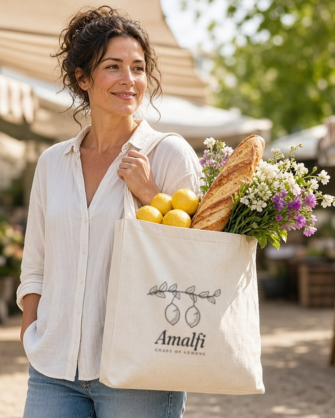 The Amalfi Tote in Oyster, overfilled and carried through a sunny farmers market
