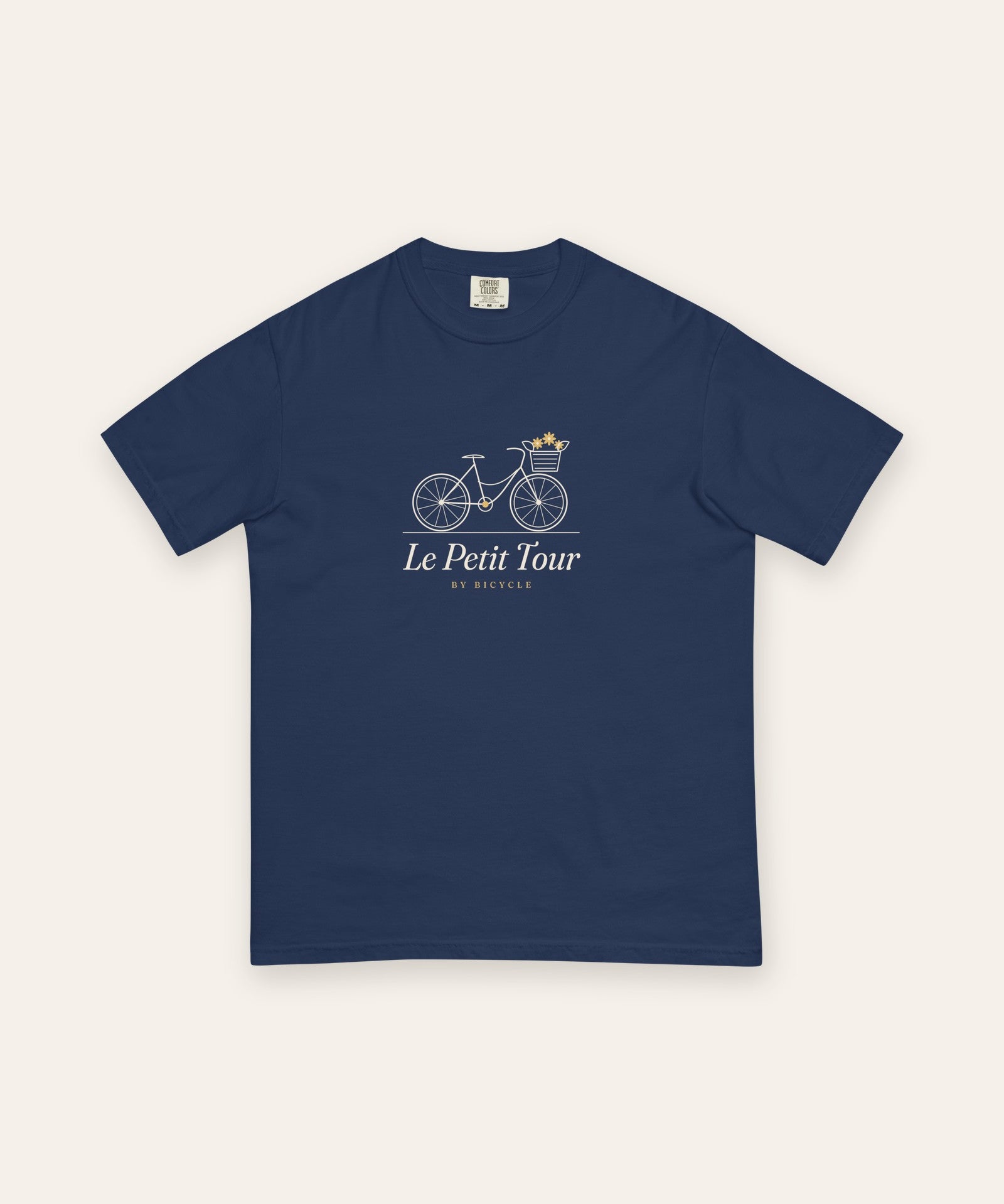 Le Petit Tour Tee in True Navy, flat lay front, product shot on cream