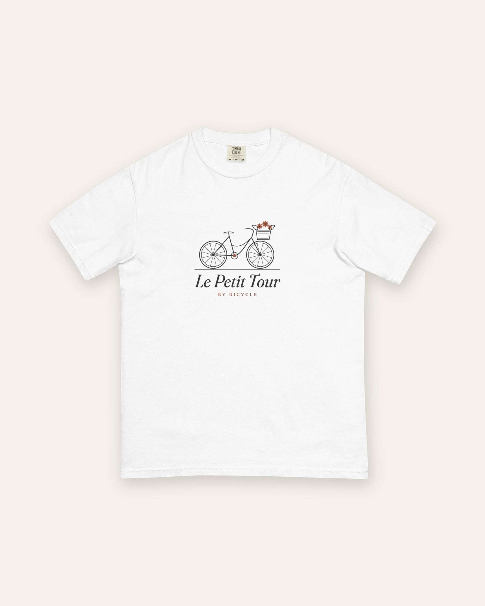 Le Petit Tour Tee in White, flat lay front, product shot on cream
