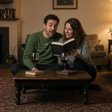 The Book Club Crewneck in Forest Green, worn on a sofa with an open book and wine on the coffee table