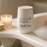 The Book Club Wine Tumbler on the edge of a bathtub with a candle and a book
