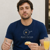 The Brunch Is My Cardio Tee in True Navy, man at a sunny breakfast table with scrambled eggs, toast and a mimosa