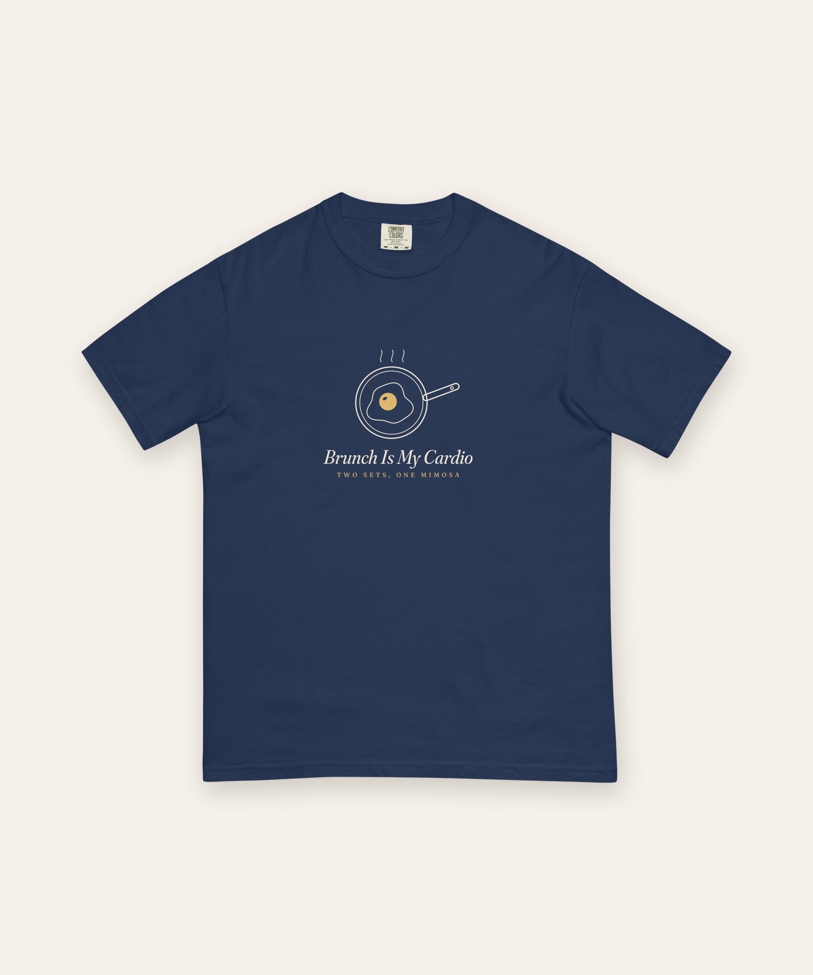 The Brunch Is My Cardio Tee in True Navy, flat lay front, product shot on cream