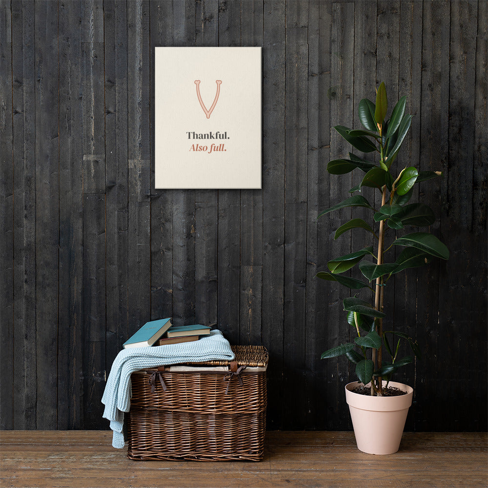 The canvas on a dark wood wall with a wicker trunk and a plant