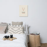 The canvas above a bed with a wooden side table