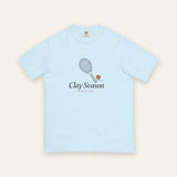 The Clay Season Tee in Chambray, flat lay front, product shot on cream