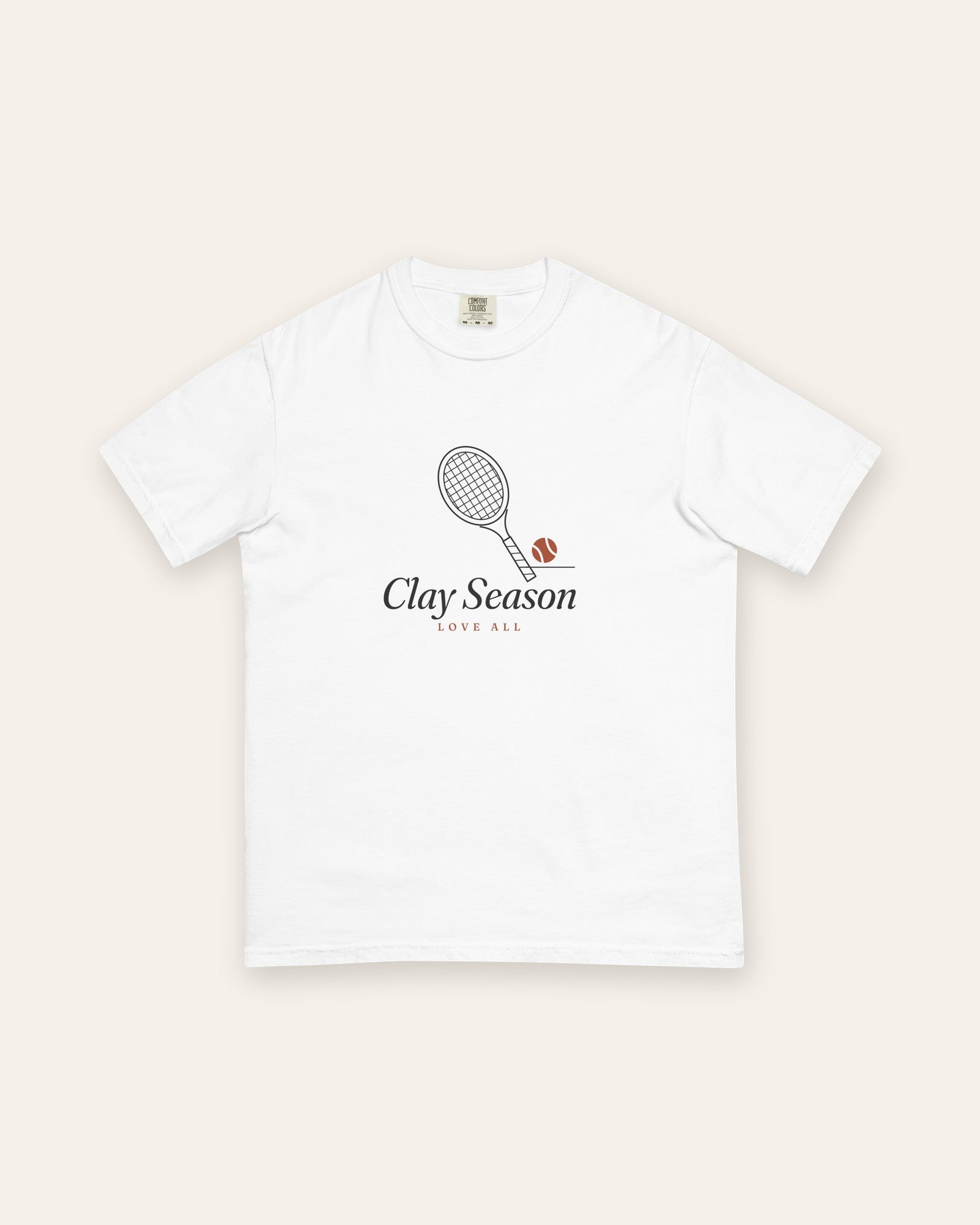 The Clay Season Tee in White, flat lay front, product shot on cream