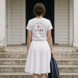 The House Crest Tee in White, woman (late 20s) on white clubhouse steps seen from behind, crest back print, racket bag in hand, soft shade