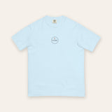 The House Crest Tee in Chambray, flat lay front, product shot on cream