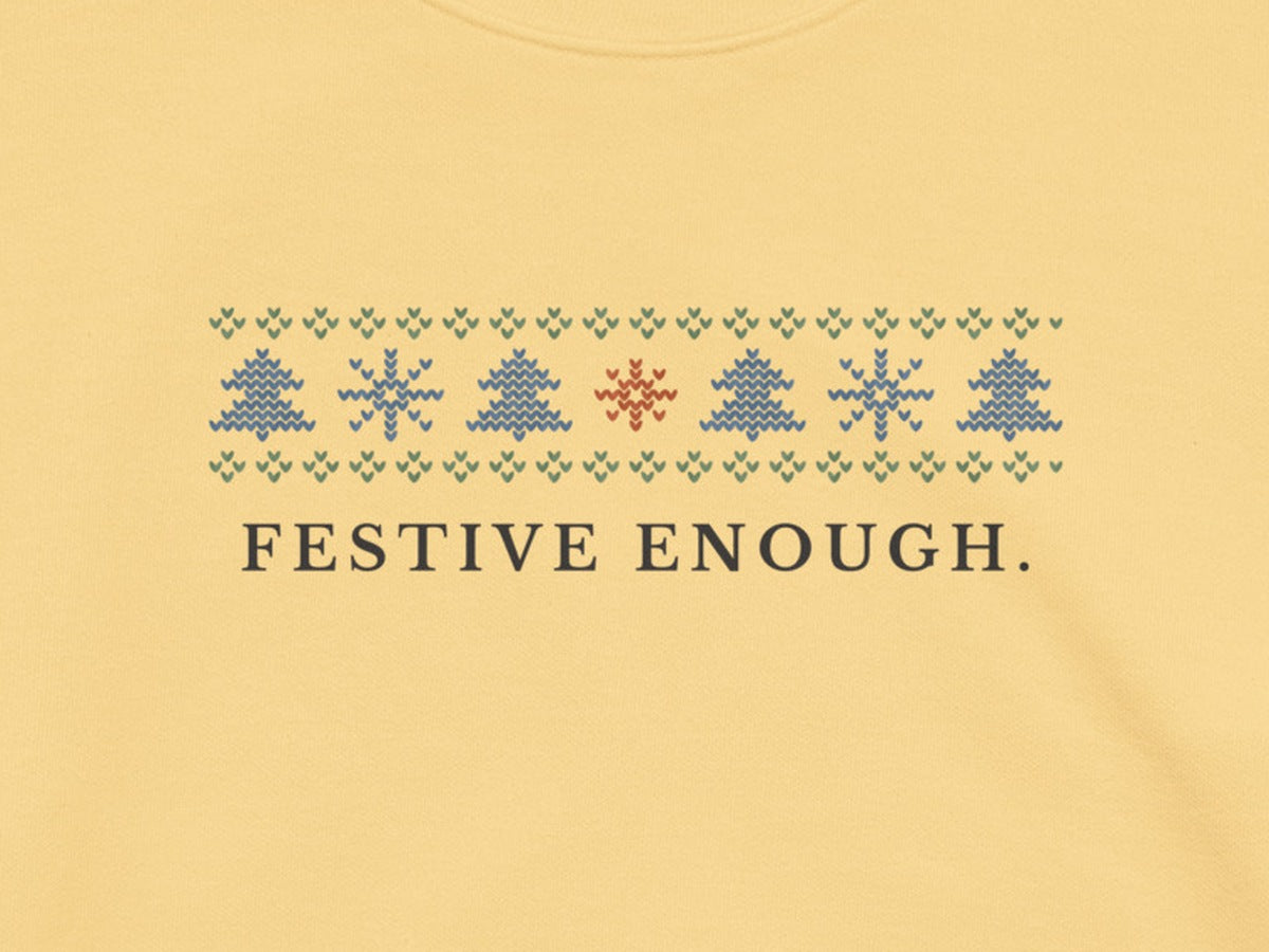 Close up of the printed Fair Isle band of fir trees, snowflakes and a terracotta star on Butter