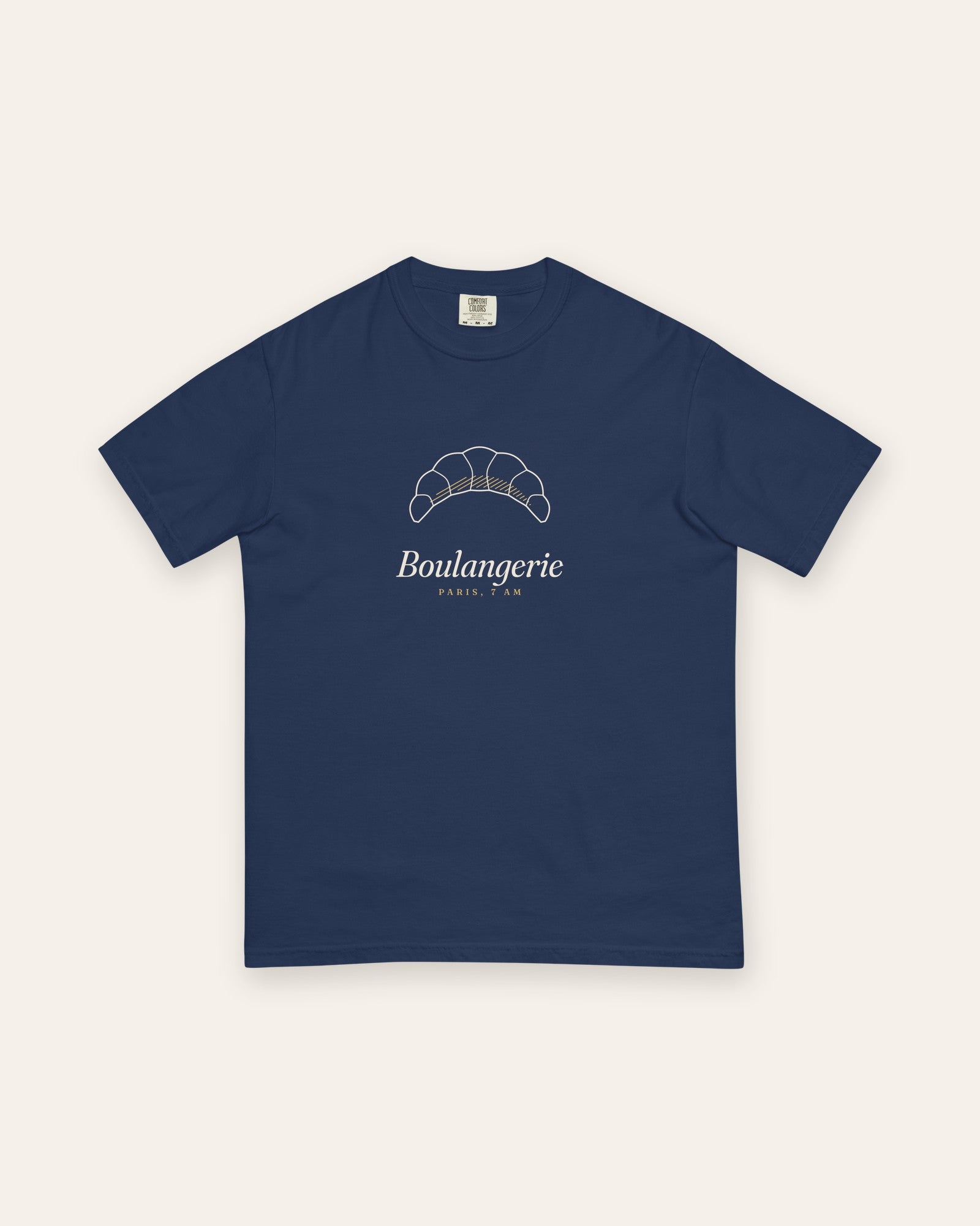 The Boulangerie Tee in True Navy, flat lay front, product shot on cream