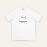 The Boulangerie Tee in White, flat lay front, product shot on cream