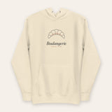 The Boulangerie Hoodie in Bone, flat lay front, product shot on cream