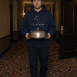 The Do Not Disturb Hoodie in Navy Blazer, worn in a hotel hallway with a room-service cloche