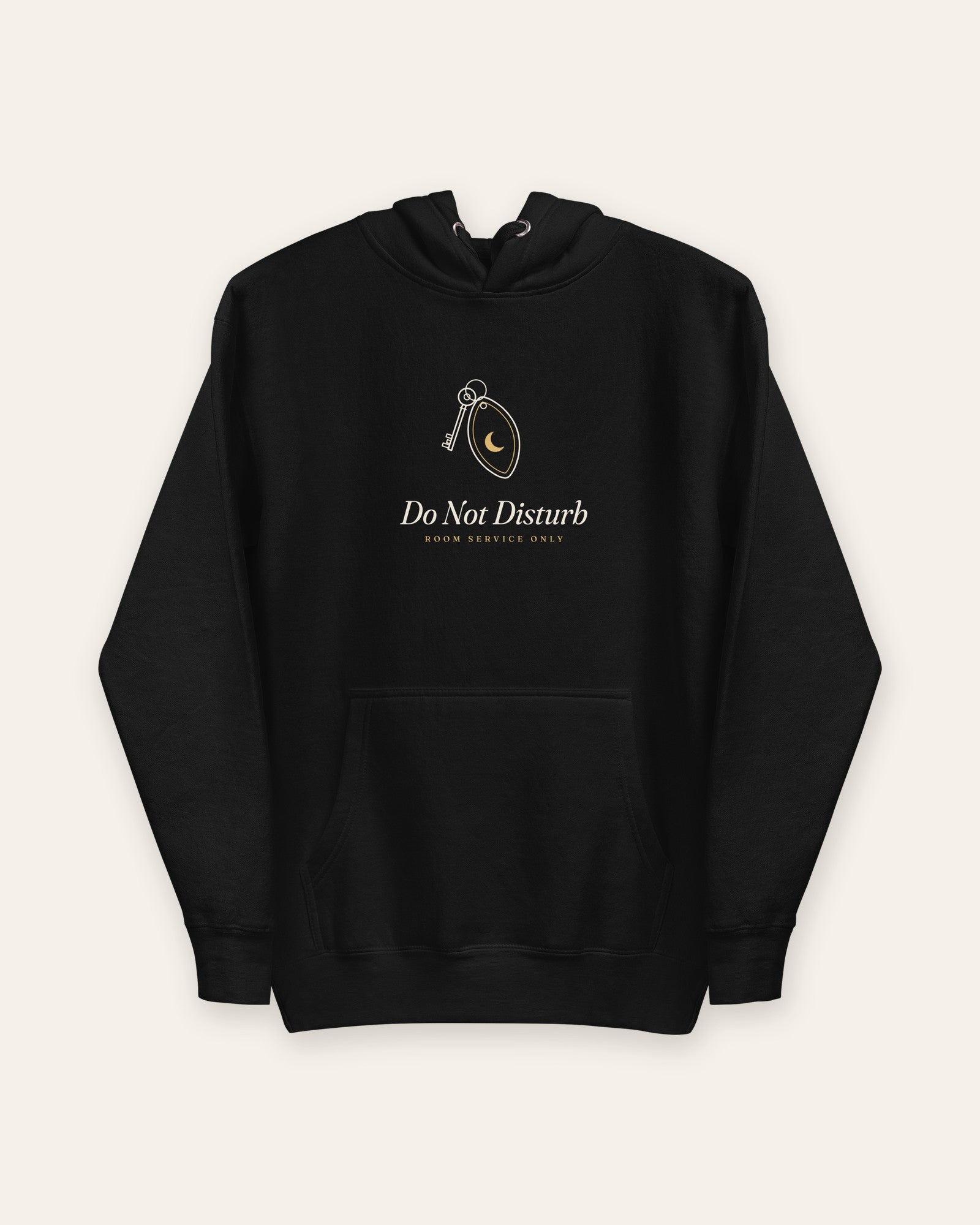 The Do Not Disturb Hoodie in Black, flat lay front, product shot on cream