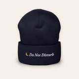 The Do Not Disturb Beanie in Navy, flat lay front, product shot on cream