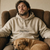 The Dog Days Hoodie in Oatmeal Heather, worn by a man asleep in an armchair with his dog on his lap