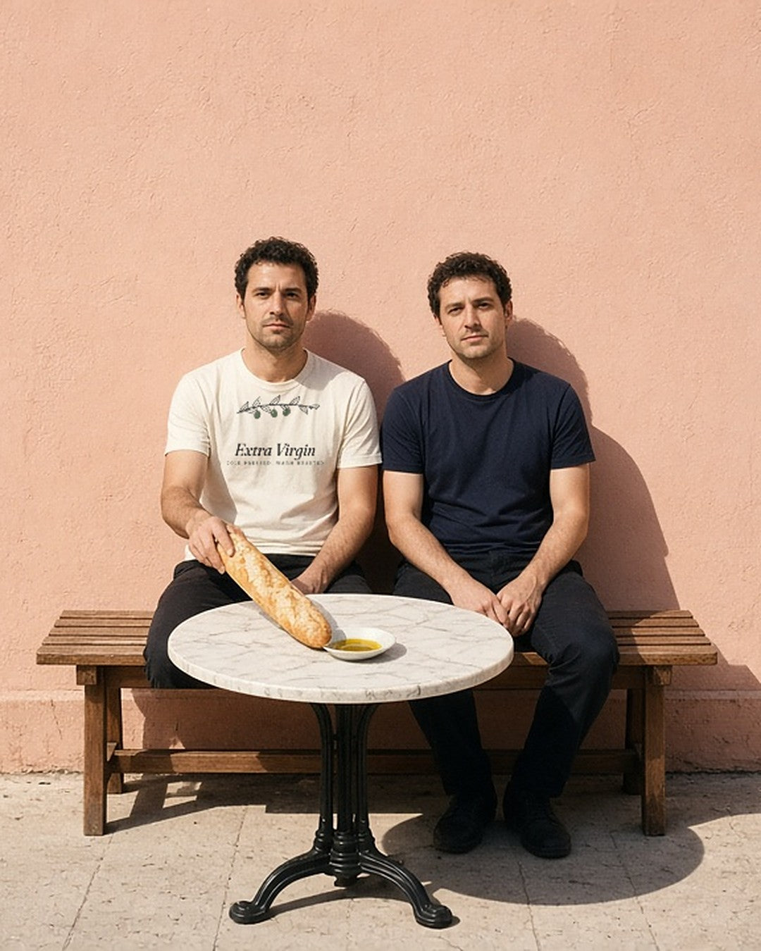 The Extra Virgin Tee in Ivory, worn by friends at a sidewalk café table with a baguette