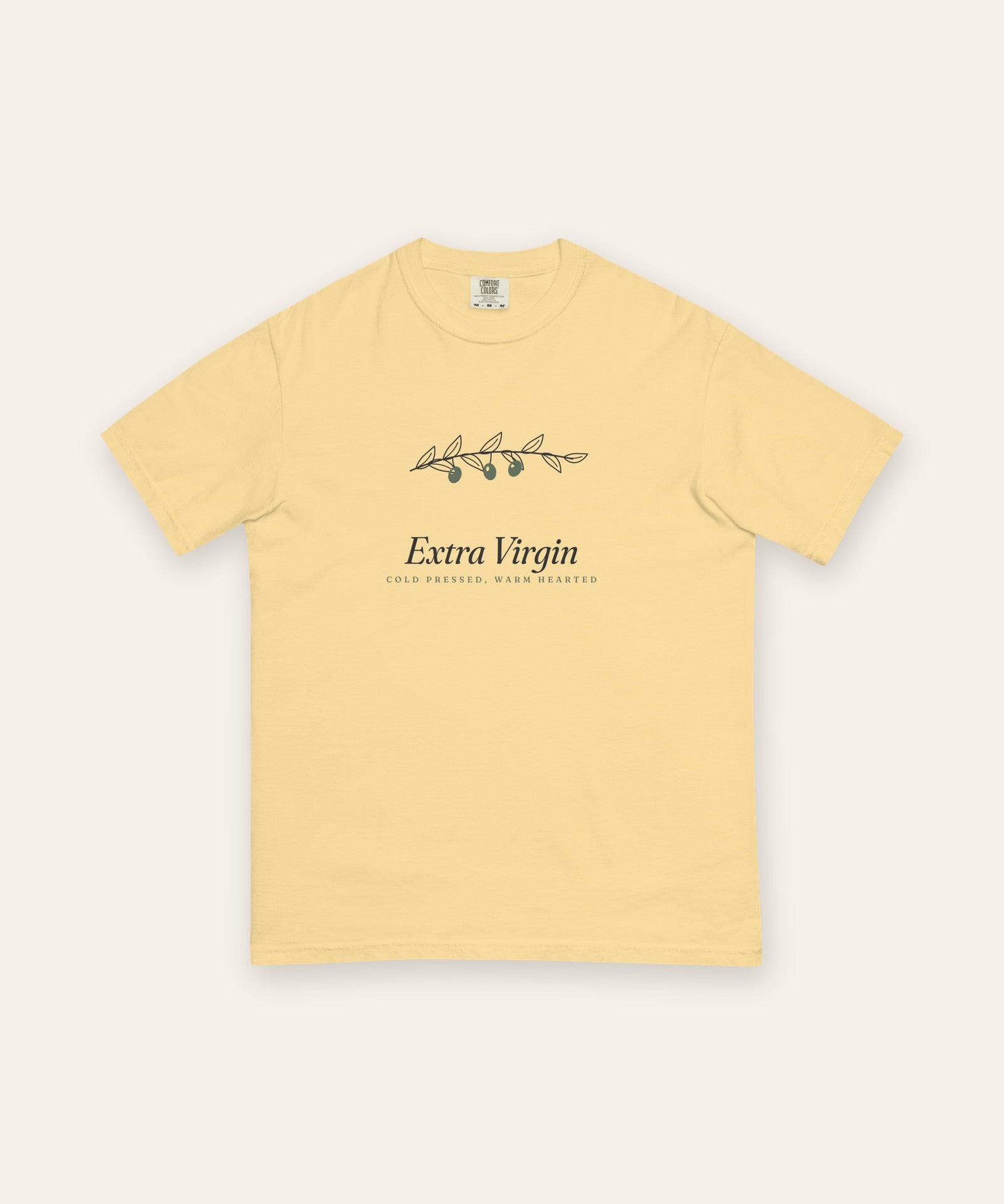 The Extra Virgin Tee in Butter, flat lay front, product shot on cream