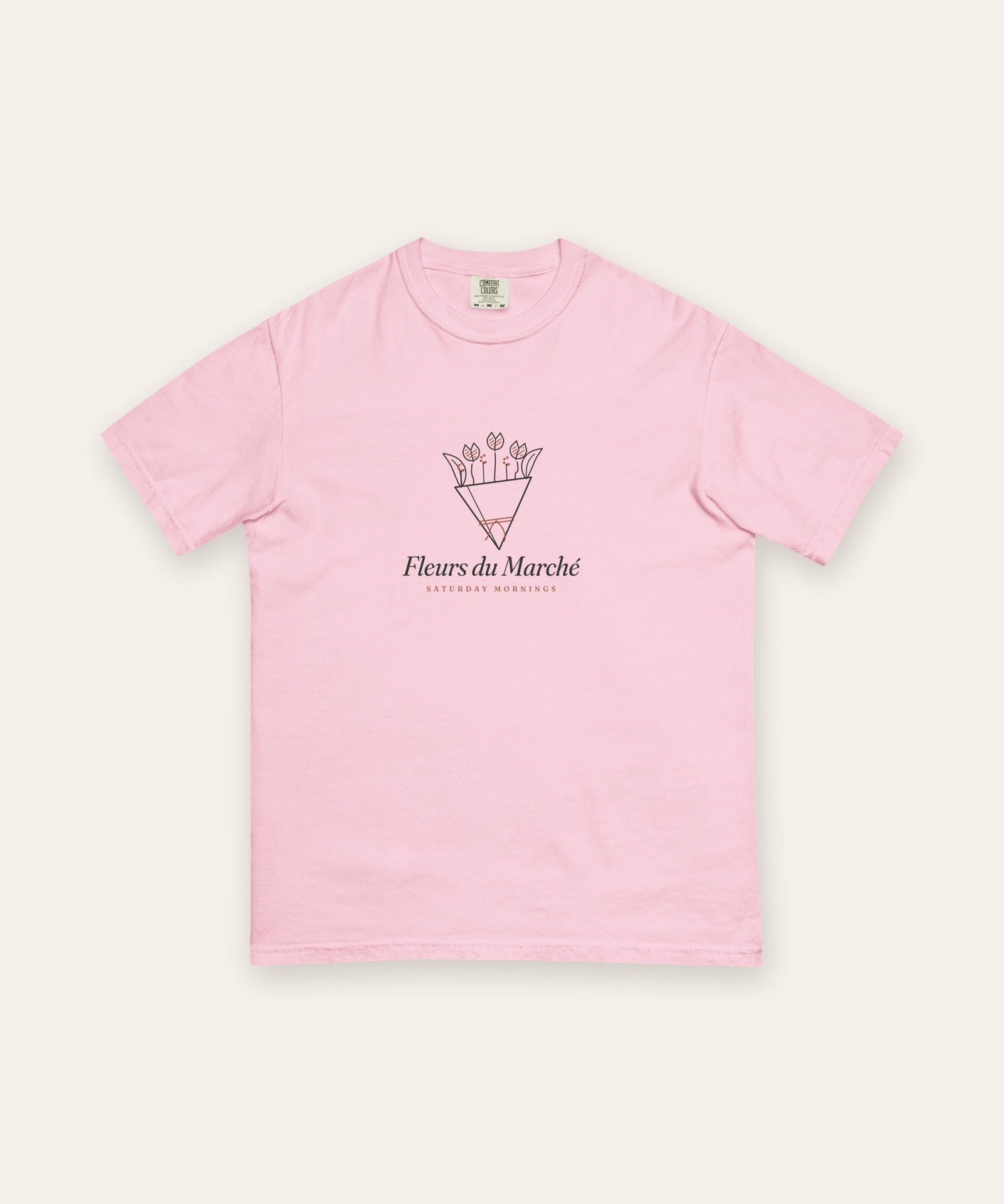 The Fleurs du Marché Tee in Blossom, flat lay front, product shot on cream