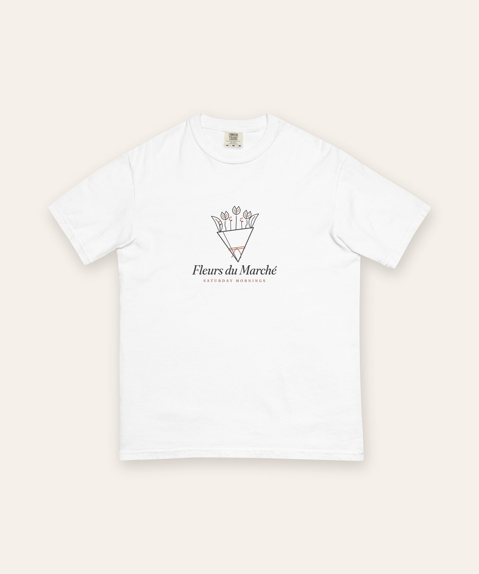 The Fleurs du Marché Tee in White, flat lay front, product shot on cream