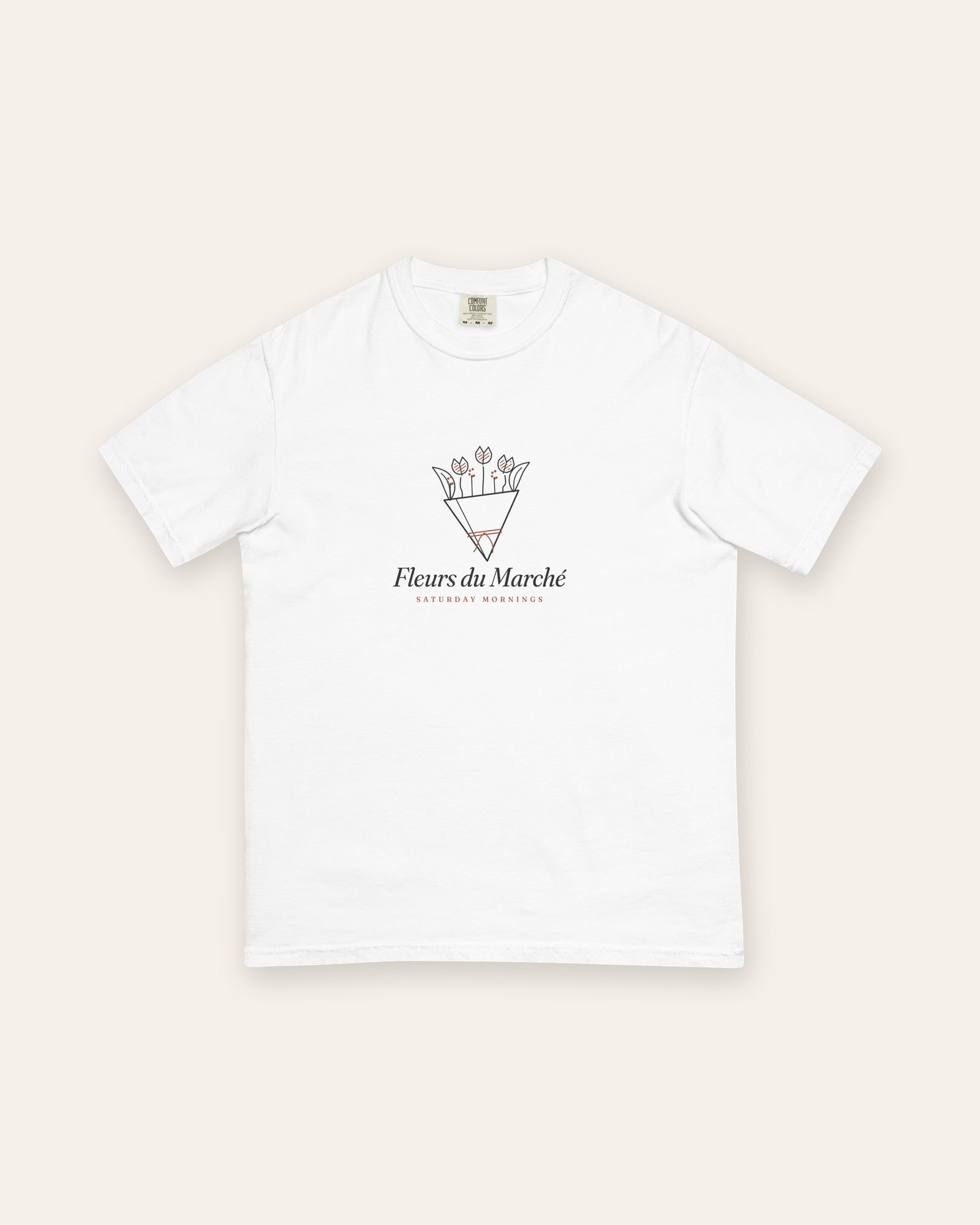 The Fleurs du Marché Tee in White, flat lay front, product shot on cream