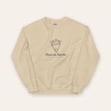 The Fleurs du Marché Crewneck in Sand, flat lay front, product shot on cream