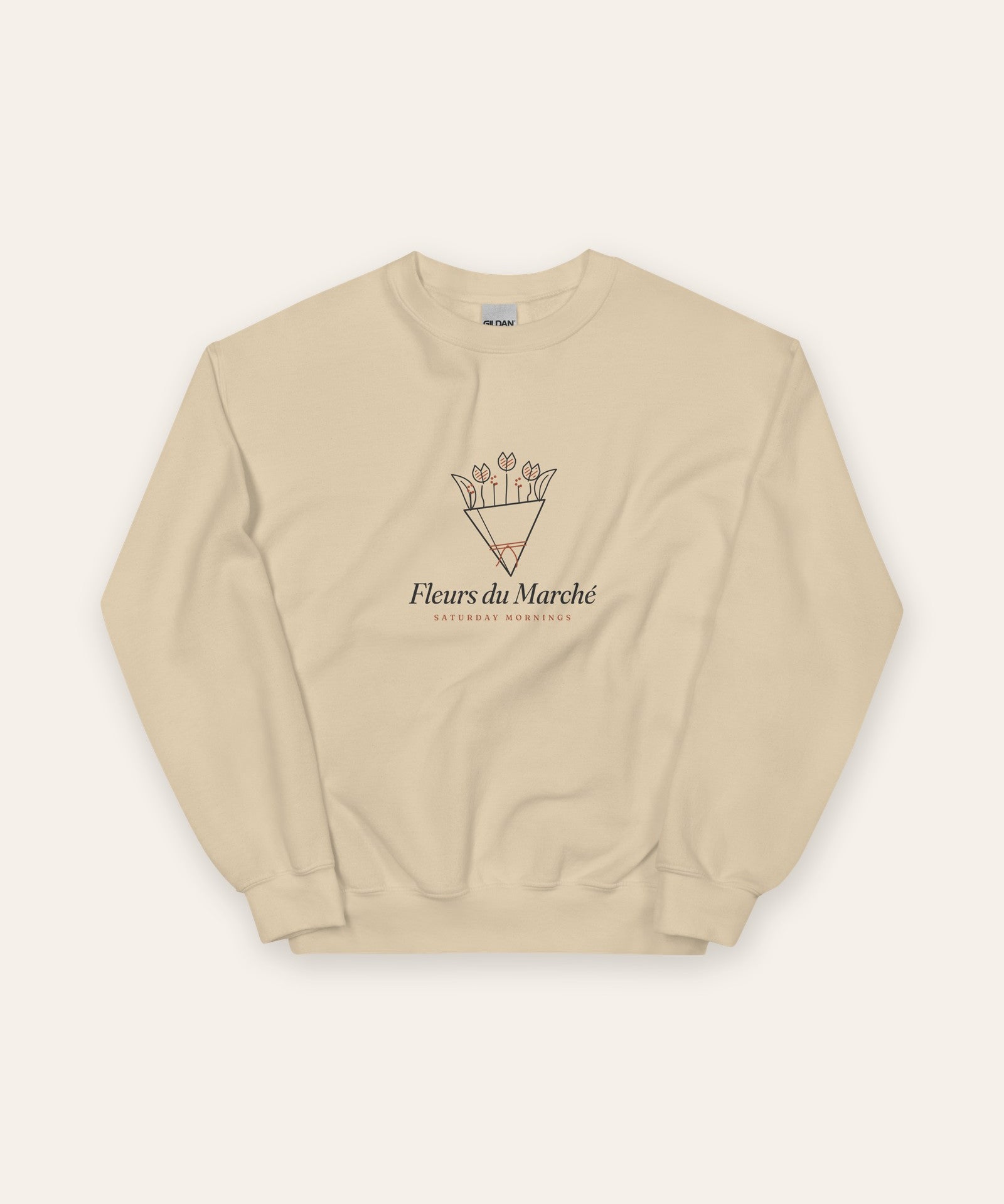 The Fleurs du Marché Crewneck in Sand, flat lay front, product shot on cream