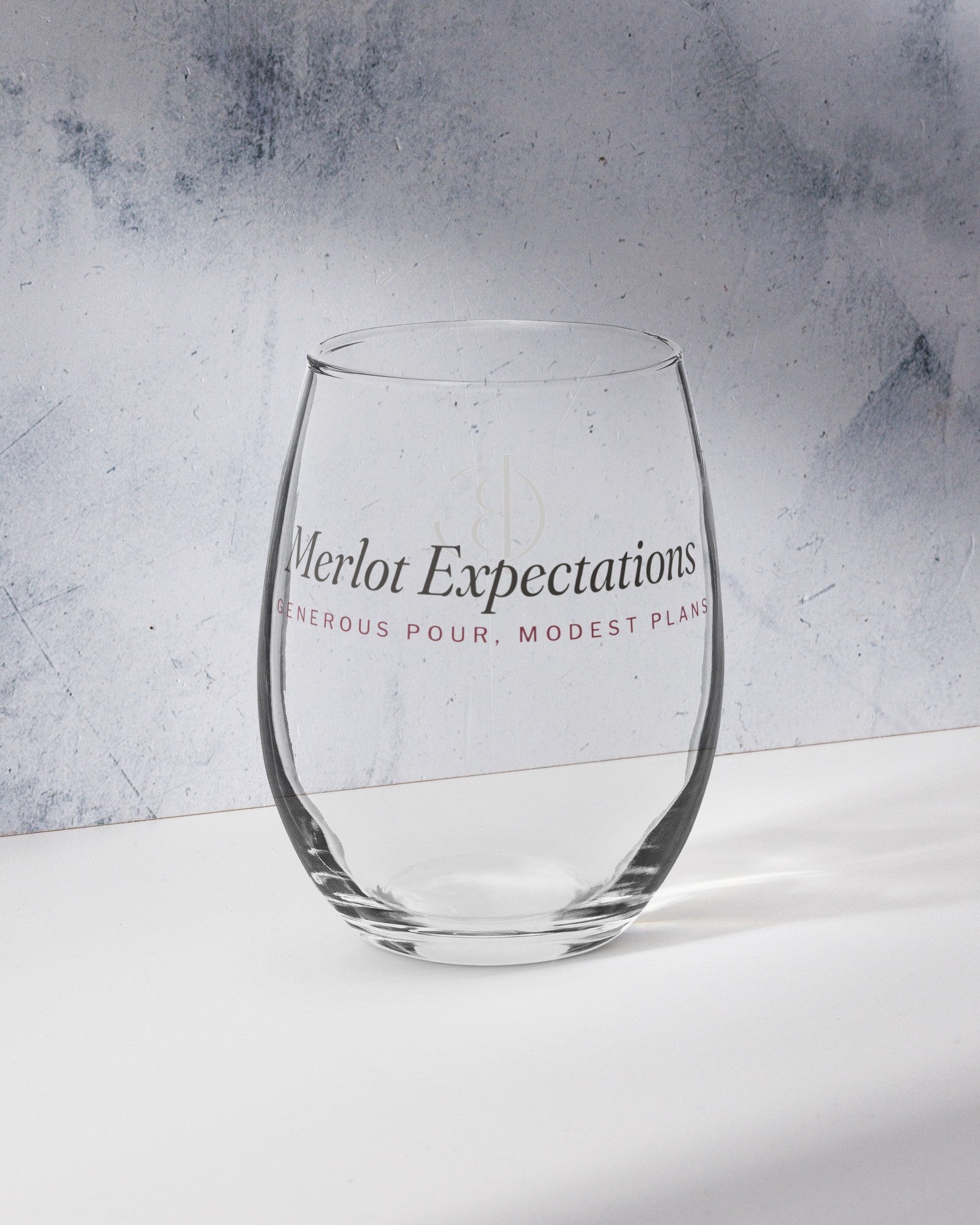The Merlot Expectations Wine Glass on a marble counter