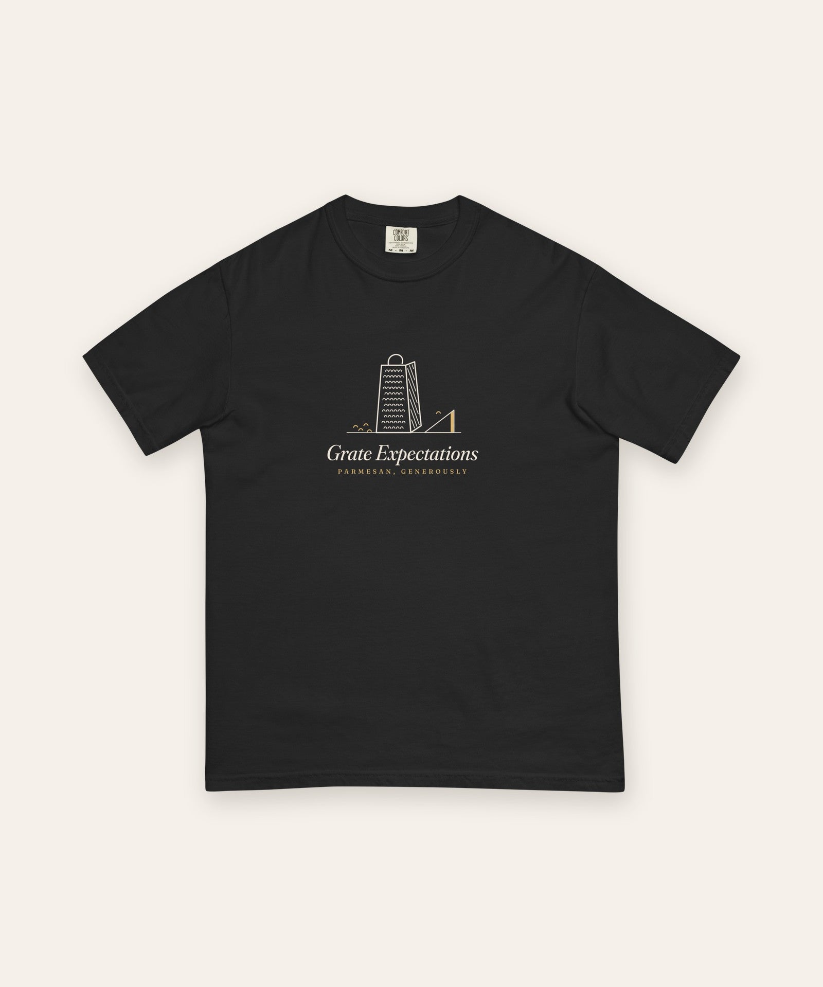 The Grate Expectations Tee in Black, flat lay front, product shot on cream
