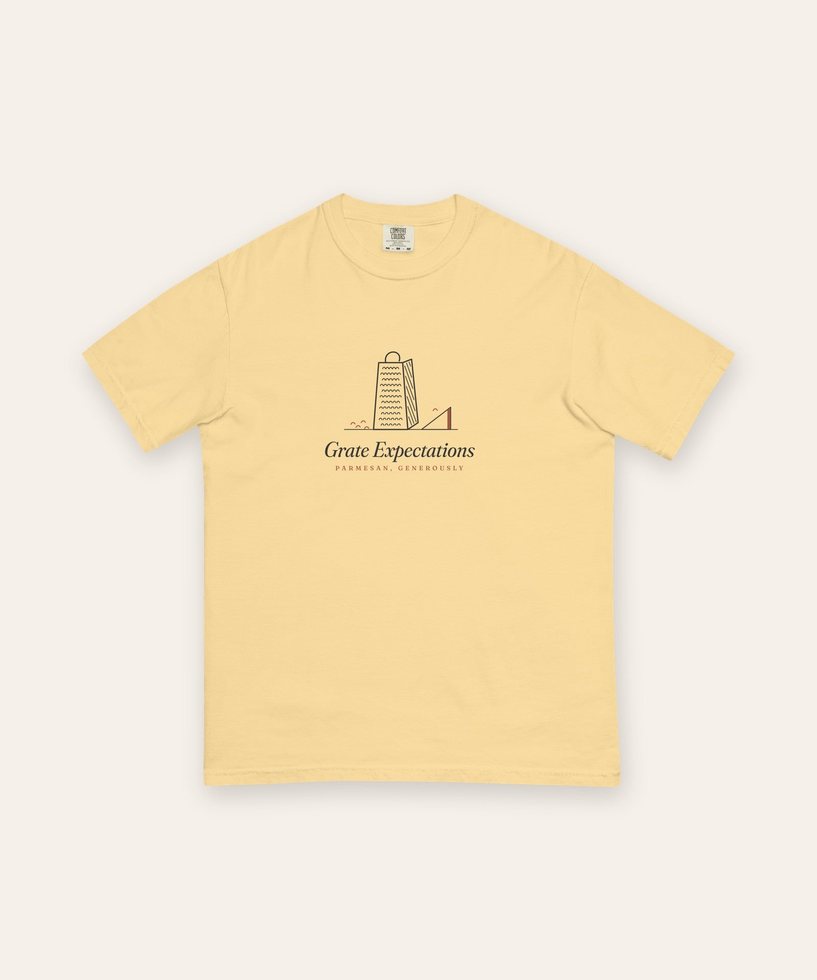 The Grate Expectations Tee in Butter, flat lay front, product shot on cream