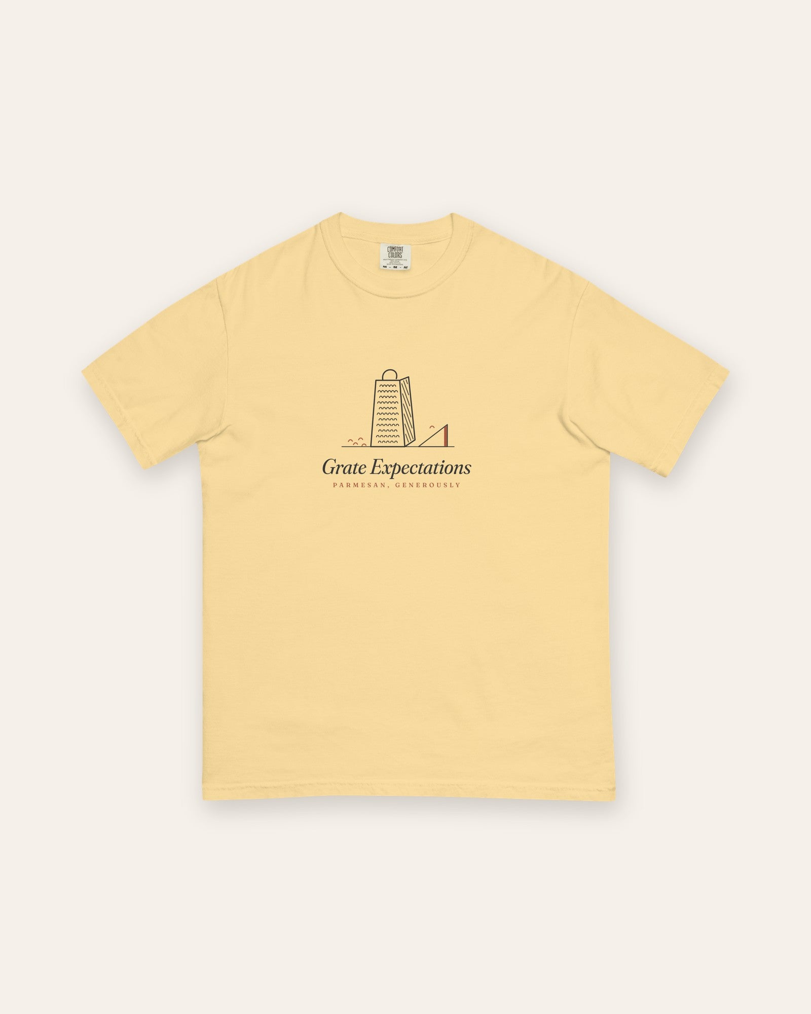 The Grate Expectations Tee in Butter, flat lay front, product shot on cream