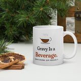 The Gravy Is a Beverage Mug on a table with pine branches and dried orange slices