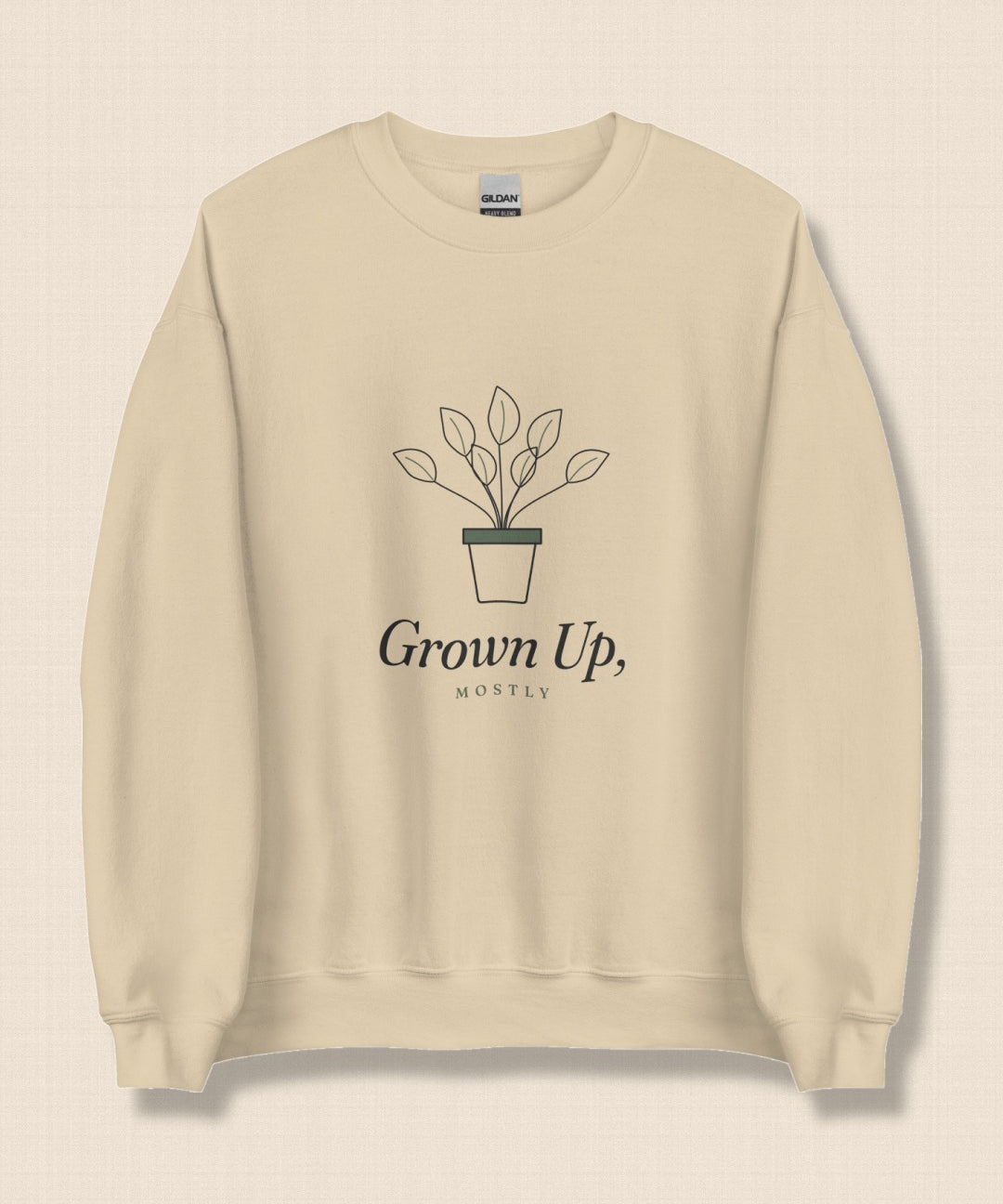 The Grown Up, Mostly Crewneck in Sand, flat lay on linen