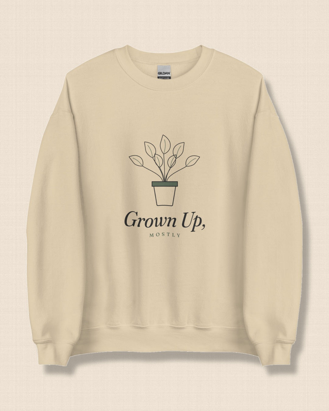 The Grown Up, Mostly Crewneck in Sand, flat lay on linen