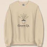 The Grown Up, Mostly Crewneck in Sand, flat lay on linen