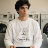 The Grown Up, Mostly Crewneck in White, reading a book on a laundromat chair