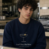 The Social Club Crewneck in Navy, at a diner counter with a slice of cake