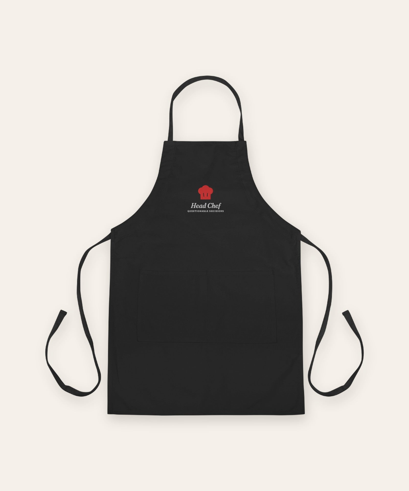 The Head Chef Apron in Black, flat lay front, product shot on cream