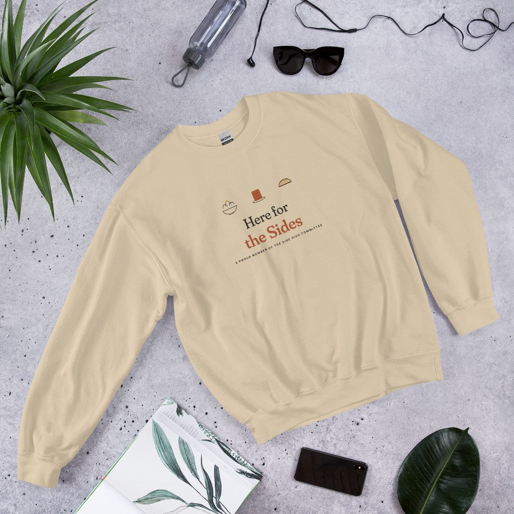 The Here for the Sides Crewneck in Sand, flat lay with sunglasses, a plant and a notebook