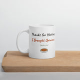 The Thanks for Hosting Mug on a wooden cutting board