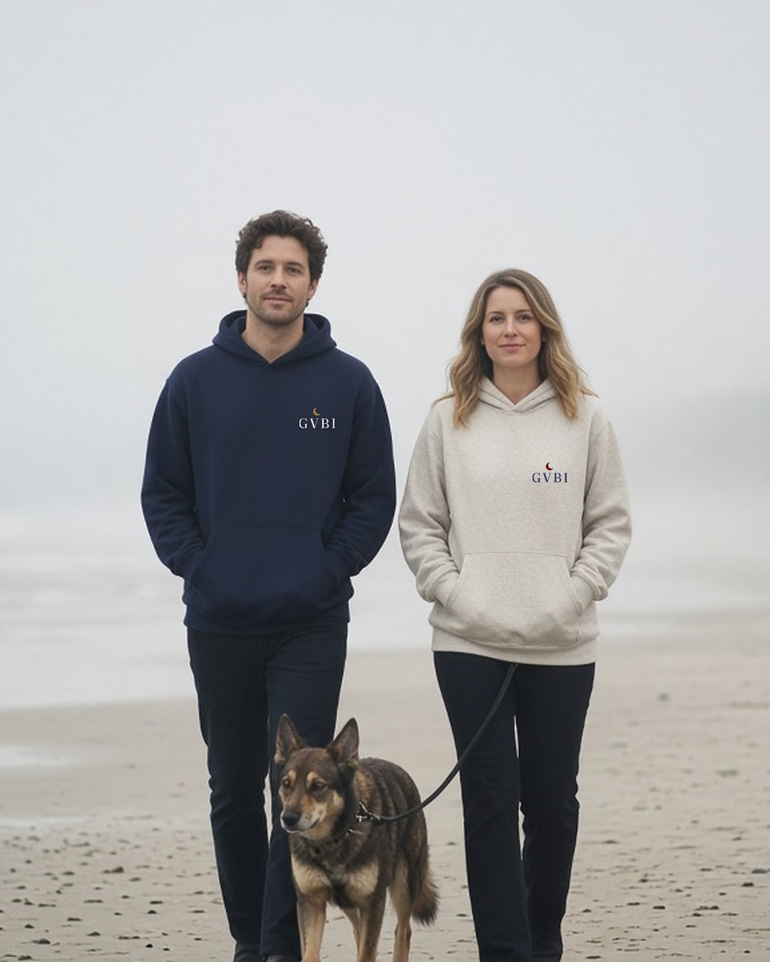 The House Hoodie in Navy Blazer + Oatmeal Heather, couple with a dog on a misty beach, he in Navy Blazer, she in Oatmeal Heather