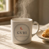 The House Mug in White, steaming mug on a sunny breakfast table next to a croissant