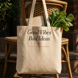 The House Tote in Oyster, tote on a wicker chair on a porch with fresh greens
