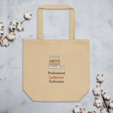 The Professional Leftover Enthusiast Tote flat on stone with cotton stems