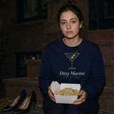 The Dirty Martini Crewneck in Navy, woman (late 20s) on brownstone steps at night with a takeout box, heels beside her, direct flash